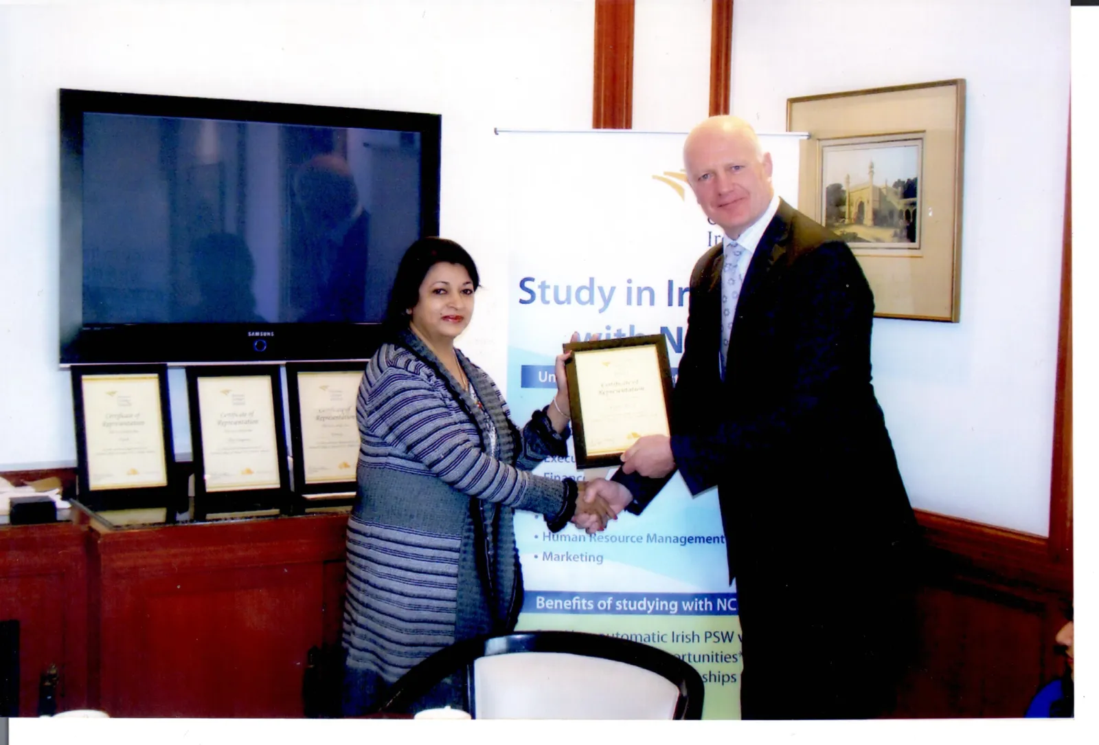 Receiving a recognition plaque from an education partner