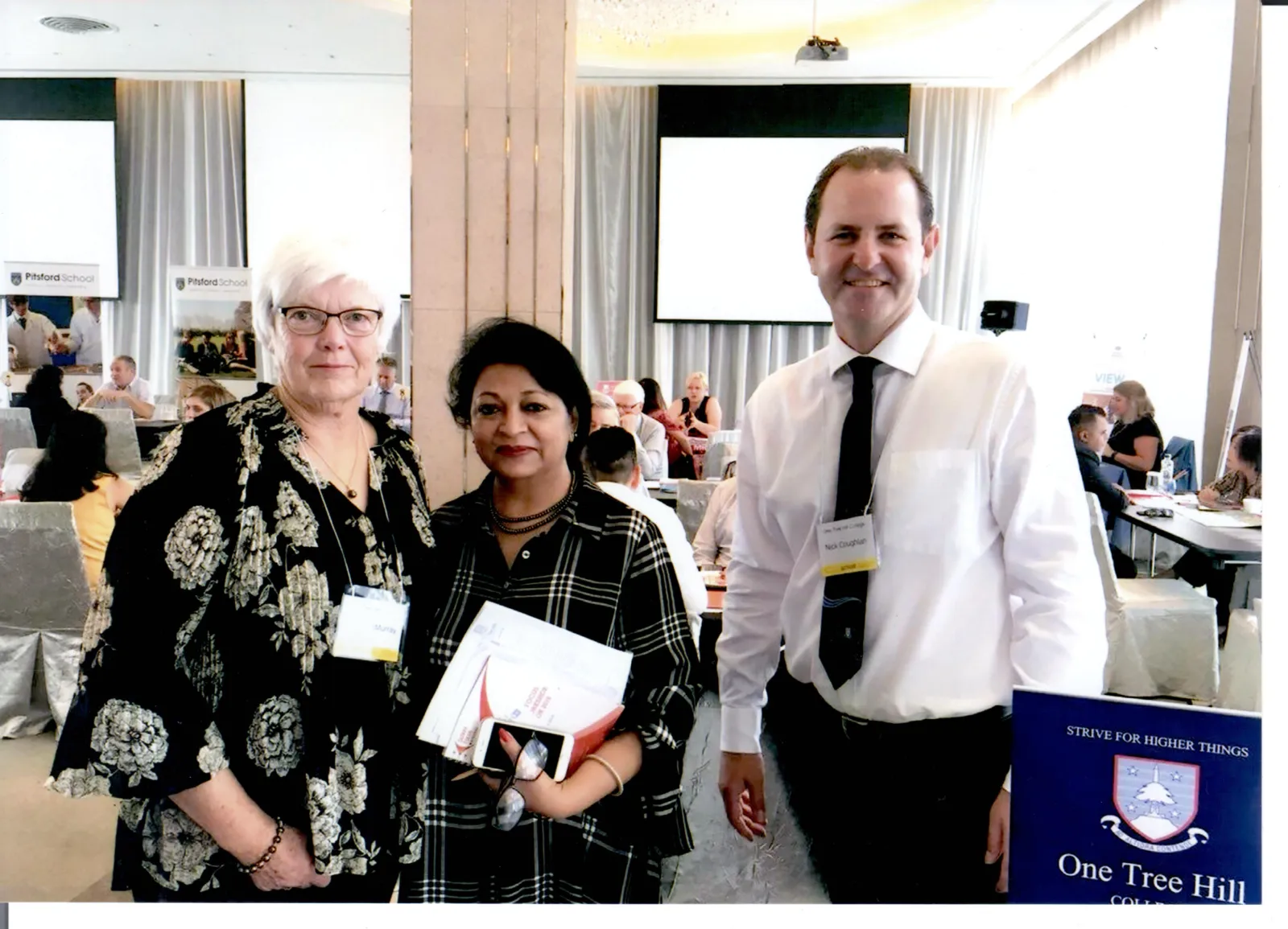 Our director with two college representatives at an education fair