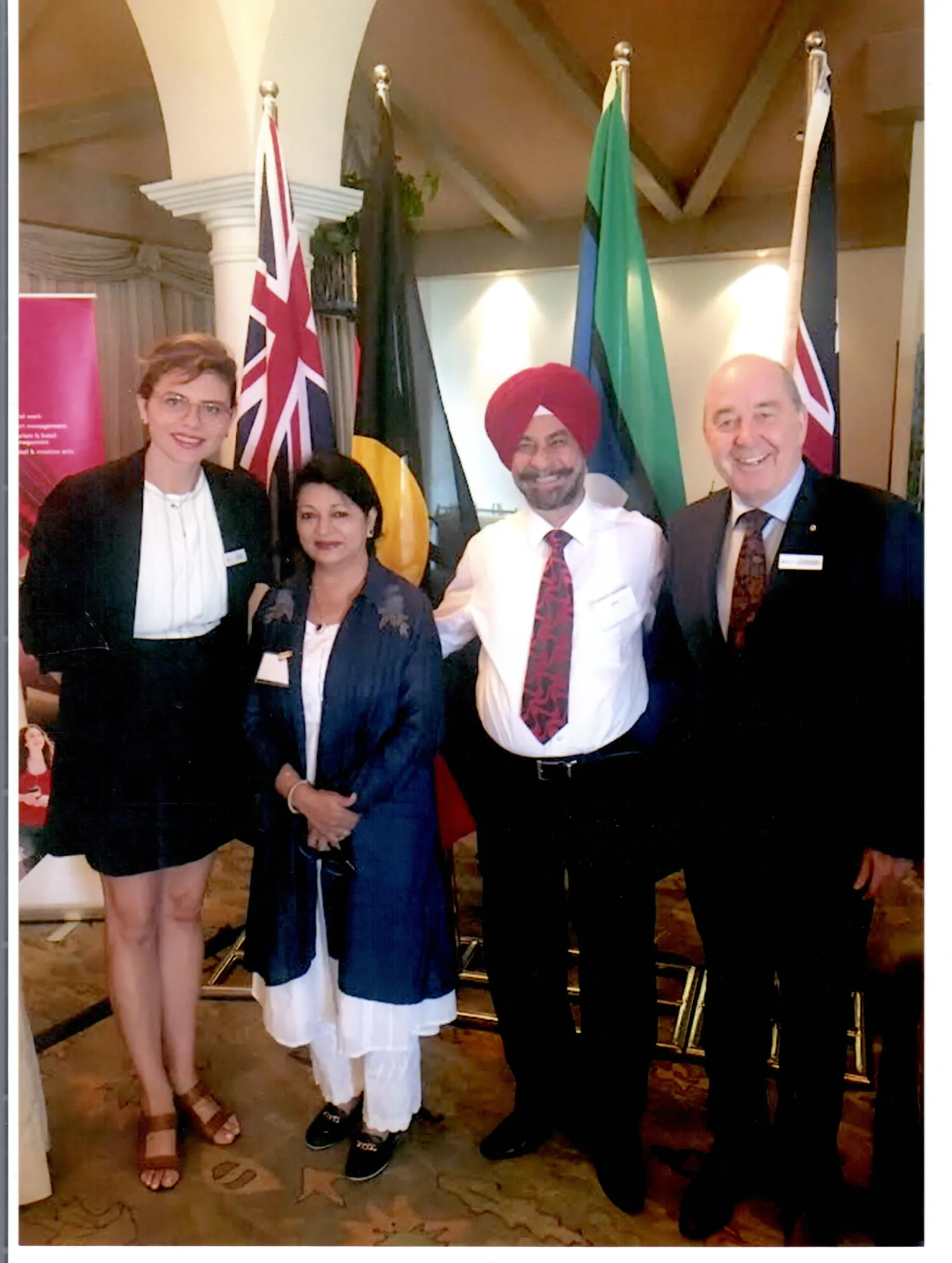 A group photo with education representatives in front of national flags